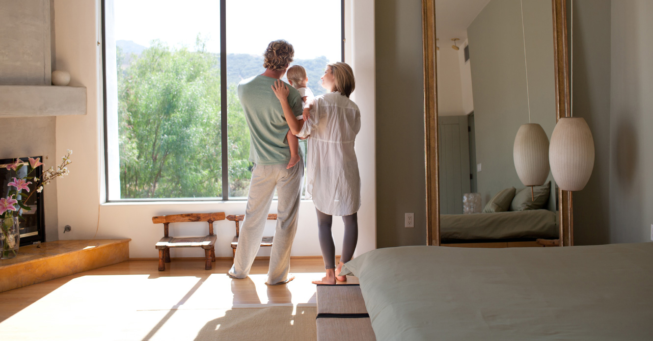 A family looking out the window of their new home