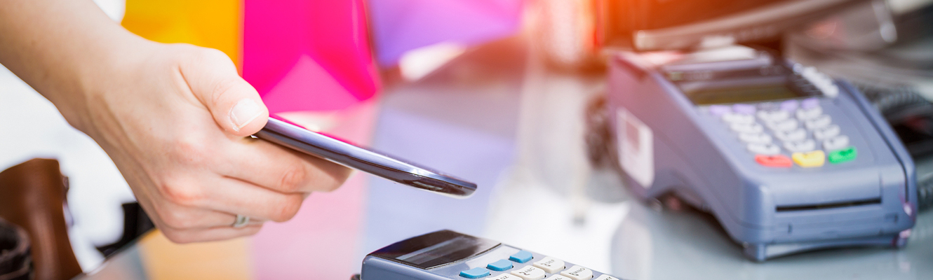 Image of person paying at the terminal with their smart phone