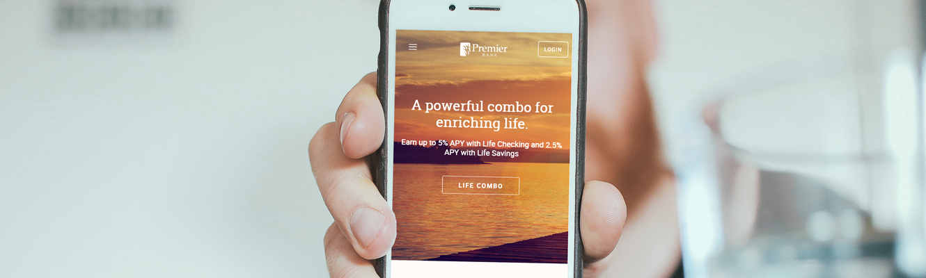 Man showing smart phone screen with new Premier Bank website