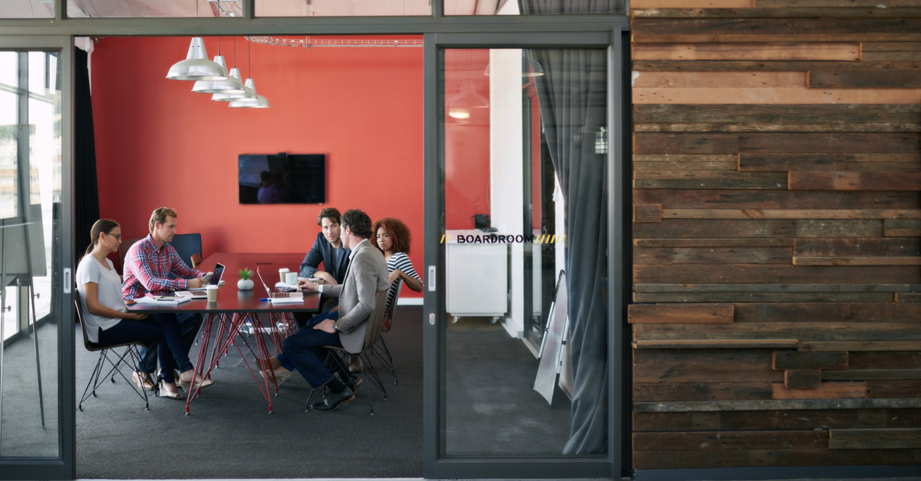 A business meeting taking place in a modern office space.