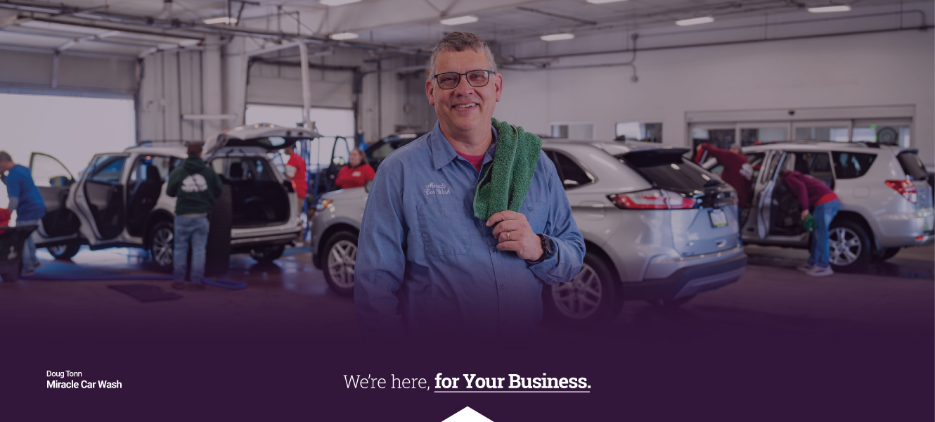 Doug Tonn of Miracle Car Wash standing in front of cars being washed.