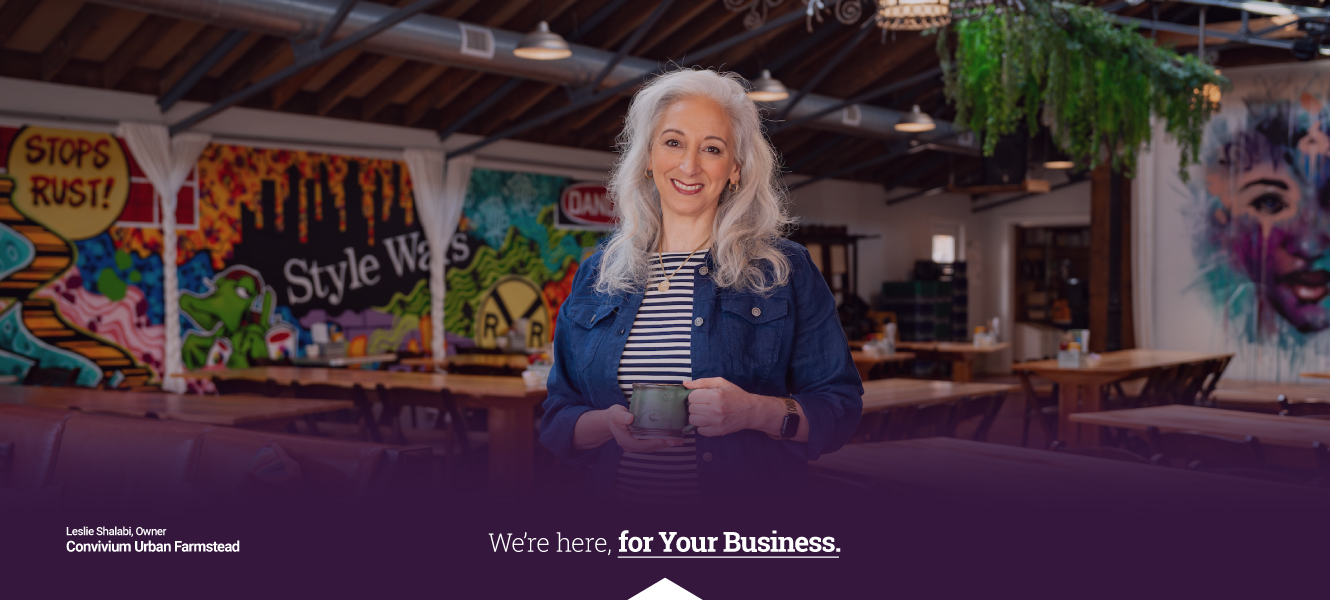 Leslie Shalabi, Owner of Convivium stands in her space with a cup of coffee
